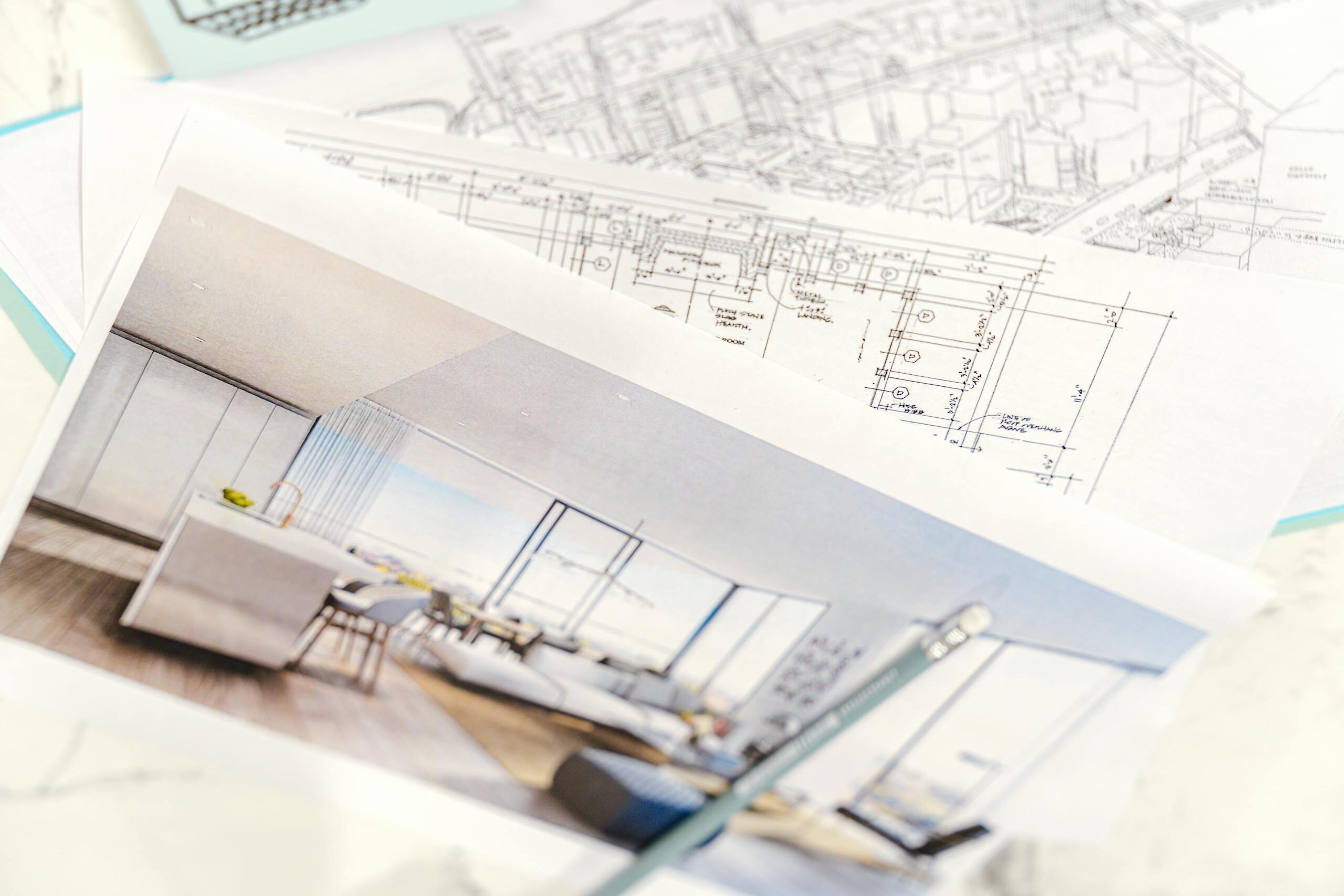 Close-up of architectural blueprints and 3D design on paper with pencil on a desk.